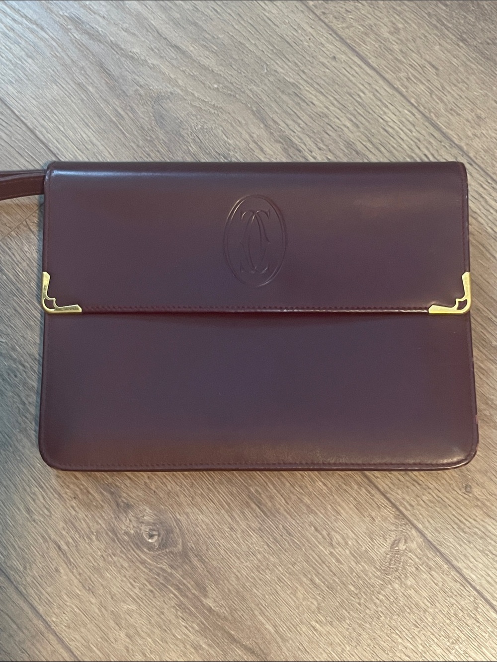 Signature Must De Cartier Bordeaux
Leather fold over flap clutch bag